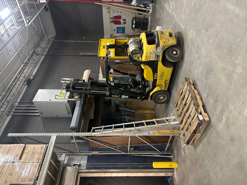 Commercial warehouse with Yale forklift and equipment during door project