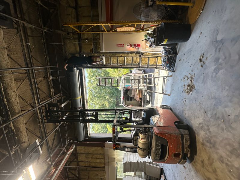 Commercial warehouse with overhead door and forklift during door service