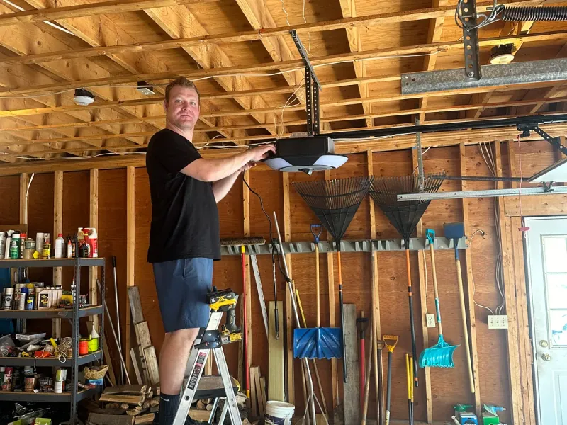 Technician replacing a garage door torsion spring